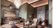 The lobby of The Crawford Hotel with check-in desk and vintage furniture sitting area.