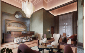 The lobby of The Crawford Hotel with check-in desk and vintage furniture sitting area.