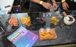 A table shows bowls of sliced grapefruit, oranges and a pestle and mortar bowl full of spices.