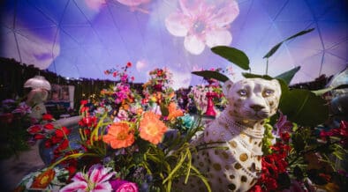 A jungle wildcat statue is surrounded by tropical flowers in the The District Dome at Desert Ridge Marketplace.