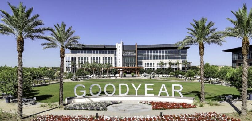 A view of Goodyear GSQ's Goodyear City Hall surrounded by palm trees and flowers.