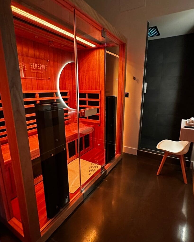 Private infrared sauna room inside Perspire Sauna Studio at The Orchard Town Center in Westminster, Colorado.