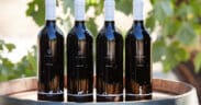 Four D.A. Ranch wine bottles atop a wine barrel as part of the ranch's Arizona Wine Club.