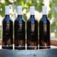 Four D.A. Ranch wine bottles atop a wine barrel as part of the ranch's Arizona Wine Club.