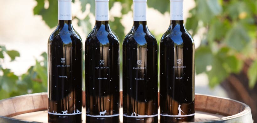 Four D.A. Ranch wine bottles atop a wine barrel as part of the ranch's Arizona Wine Club.