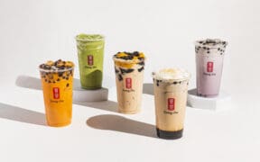 Five flavors of Gong cha bubble tea in large cups, including matcha, coffee and Thai tea flavors.