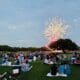Guests of the Hyatt Regency Hill Country Resort and Spa sit on the property's lawn watching fireworks.