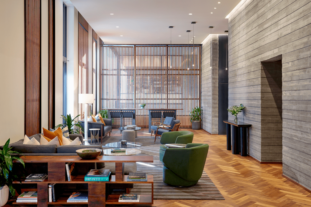 The lobby of the Limelight Boulder with a seating area of chairs bench seating and natural light.