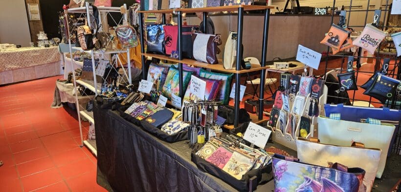 Multiple tables and shelves are set up with artisan goods at the Pine Ridge Marketplace Artisan Market.