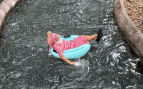Santa in pajamas on a donut floatie, cruising down the Hyatt Regency Hill Country Resort lazy river.