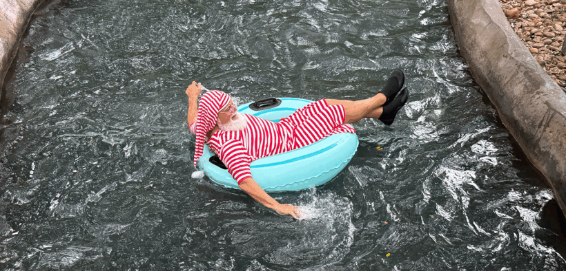 Santa in pajamas on a donut floatie, cruising down the Hyatt Regency Hill Country Resort lazy river.