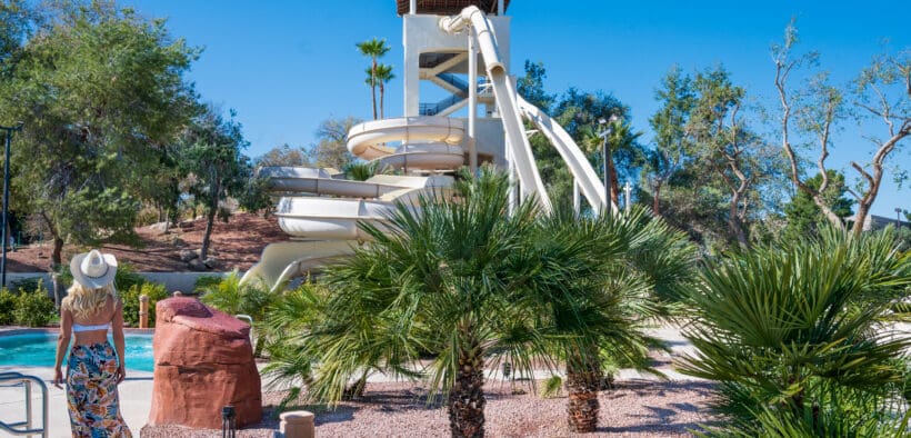 A woman walks toward the Arizona Grand Resort's Oasis Water Park Slide.