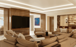 A Strip Suite living room at Green Valley Ranch Resort with family style couch, full bar, TV and views of the Vegas strip.