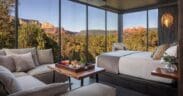 A open-window atrium with bed, couch and a charcuterie tray on a table overlooking Sedona.