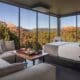 A open-window atrium with bed, couch and a charcuterie tray on a table overlooking Sedona.
