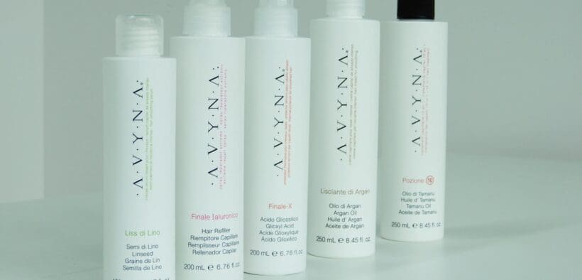 A line of Avyna Cosmetics hair products lined up on a counter.