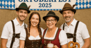 A family wearing traditional German garments pose together in a photo booth for the Fountain Hills Oktoberfest 2025