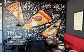 A painted mural of pizza slices at Lorenzo's Italian Kitchen.