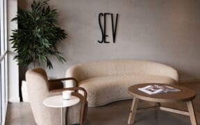 Waiting area with modern couch, chair and coffee tables at SEV Laser in Chandler.
