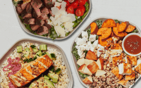 Three bowls from Sweetgreen with salmon, sweet potatoes and steak.