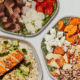 Three bowls from Sweetgreen with salmon, sweet potatoes and steak.
