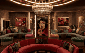 A velvet red circular couch below a stunning chandelier with forest green velvet half circle couches and Mexican-inspired decor at Pablo's Downtown Phoenix.