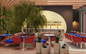 Vivili Hospitality's new Hero restaurant with indoor trees and modern seating and tables.