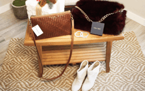 A leather woven purse, Arlo fur back with gold chain, otther bracelts and leather boots in a bright room.