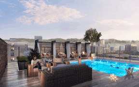 People lounge on sofas and the pool on the rooftop of Le Méridien & Element Salt Lake City.