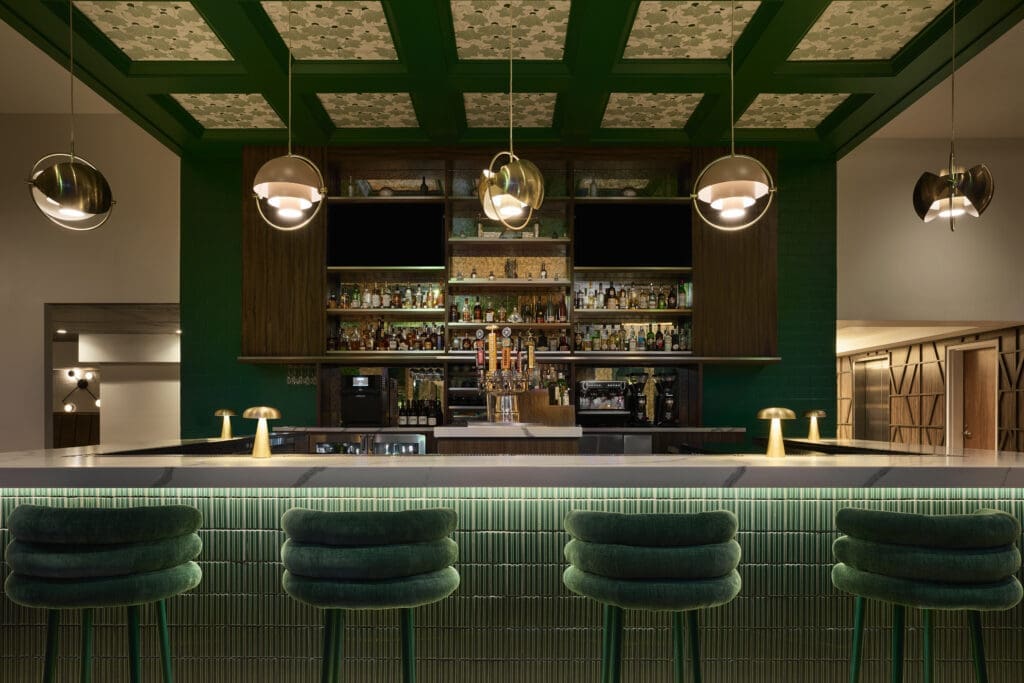 Green-tiled cocktail bar at Canvas Café and Lounge in downtown San Diego featuring modern lighting and a polished, intimate atmosphere.