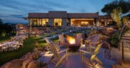Fire bowl surrounded by seating on a landscaped event lawn at Sanctuary Camelback Mountain Resort & Spa at dusk