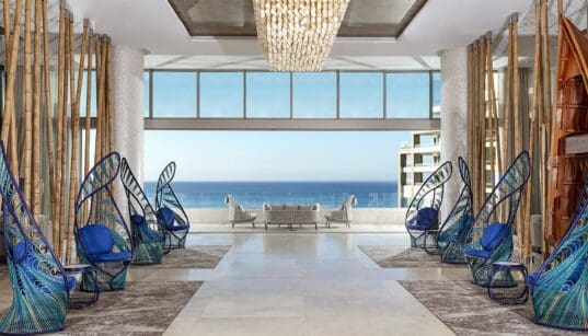 Open-air lobby at Garza Blanca Resort & Spa Los Cabos with ocean views and modern coastal design