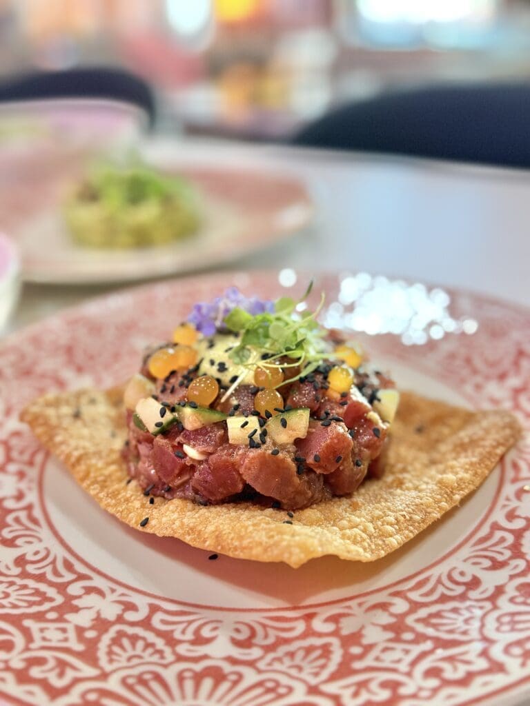 Tuna Tartare sits atop a tortilla chip on a decorative Mexican-style plate at Camello restaurant in Phoenix.