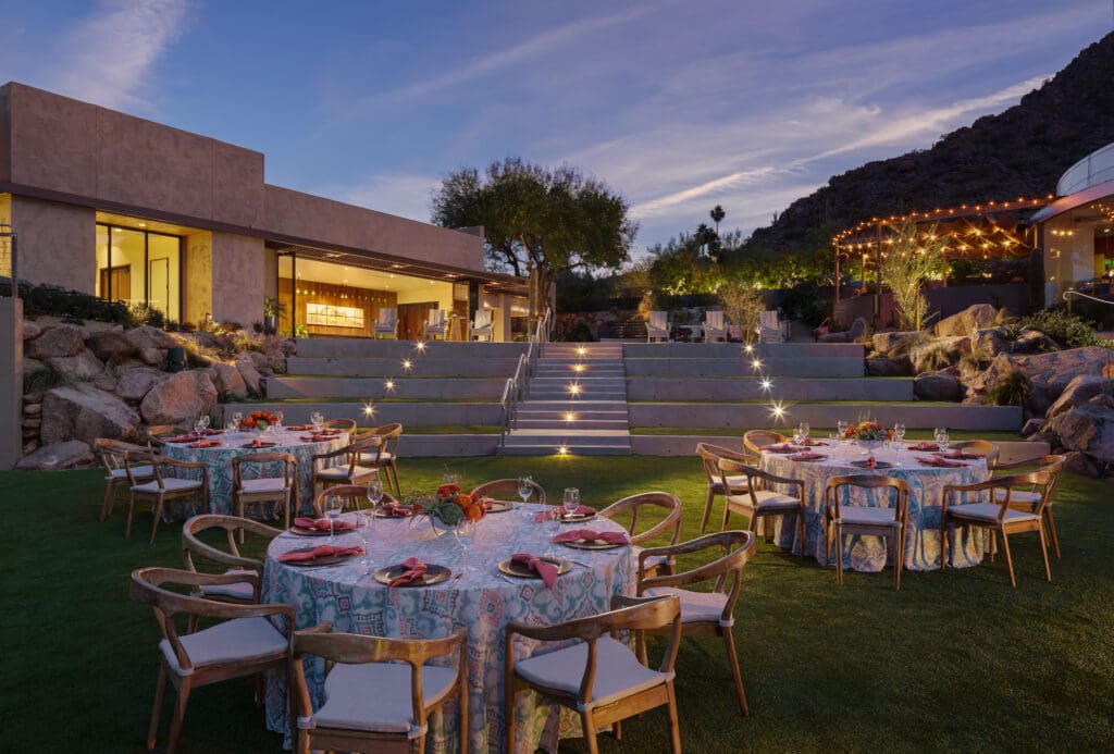 Outdoor dining tables set on the Lower Lawn at Sanctuary Camelback Mountain Resort & Spa for a private event.