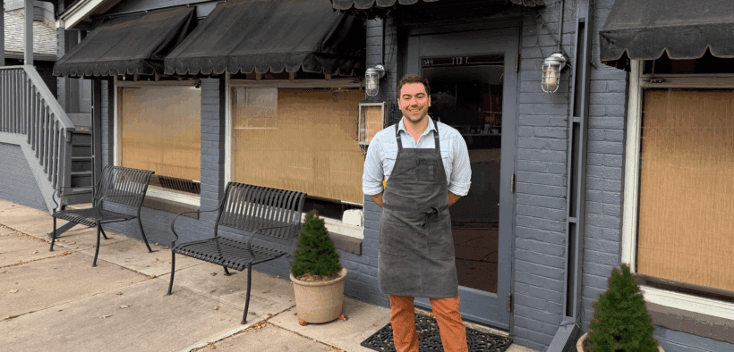 Chef Quincy Cherrett wearing an apron in front of Madeline restaurant in Denver.