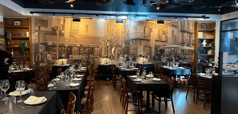 Pizzicata Glendale's dining area with old world Italy decor with matching wall mural and elevated table settings.