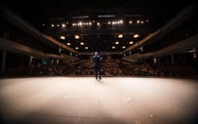 A man on a stage of a theatre during the Sedona International Film Festival.