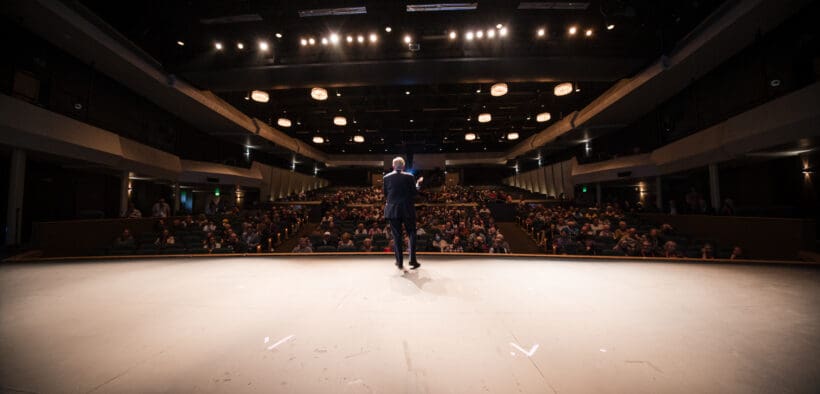 A man on a stage of a theatre during the Sedona International Film Festival.