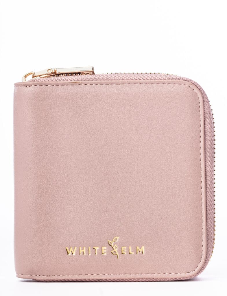 White Elm Starla wallet in dusty rose with zip-around closure and subtle gold branding, photographed on a clean white background.