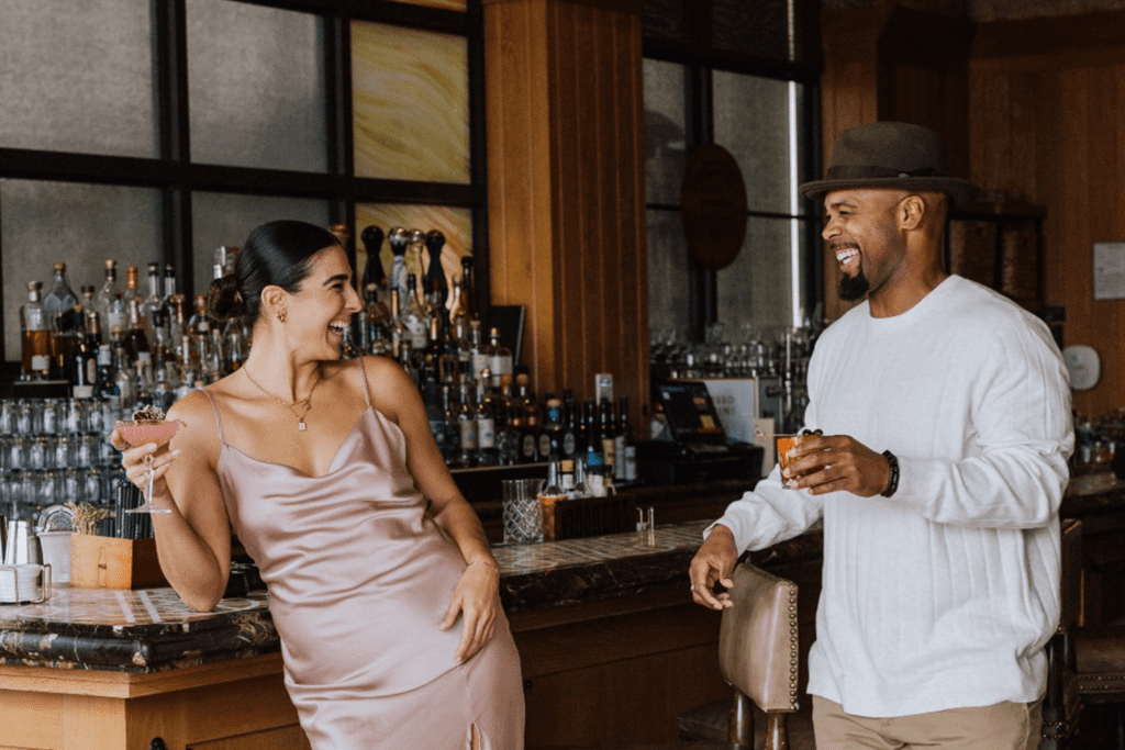 Couple enjoying cocktails at a bar at Terranea Resort, capturing a relaxed and romantic Southern California coastal atmosphere.