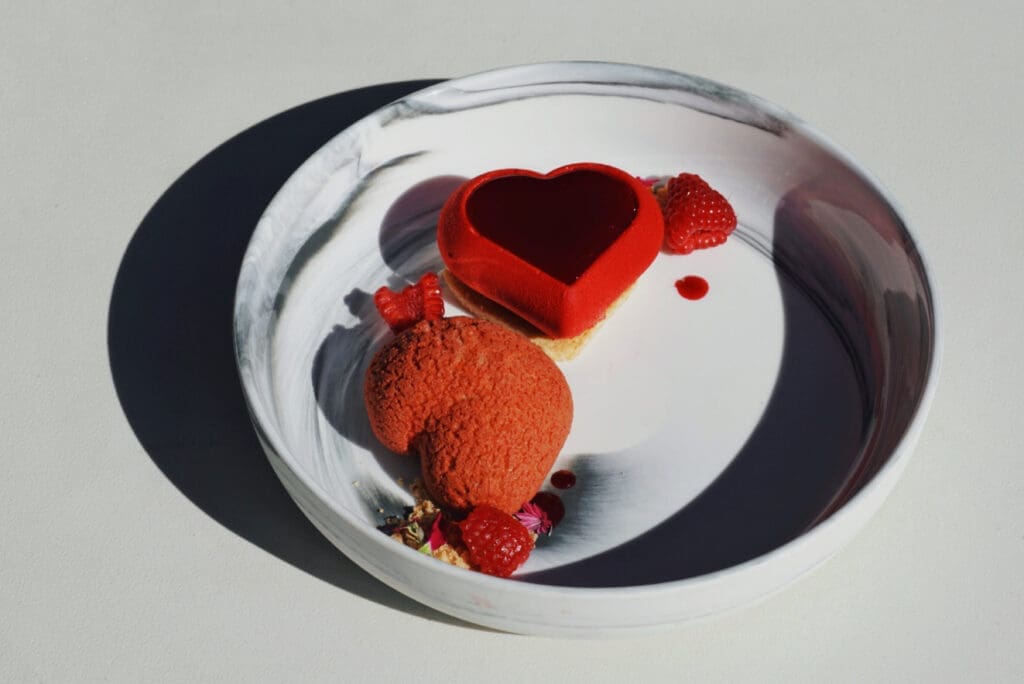 Red velvet heart-shaped Valentine’s dessert with fresh raspberries and sauce at Weft and Warp Kitchen at Andaz.