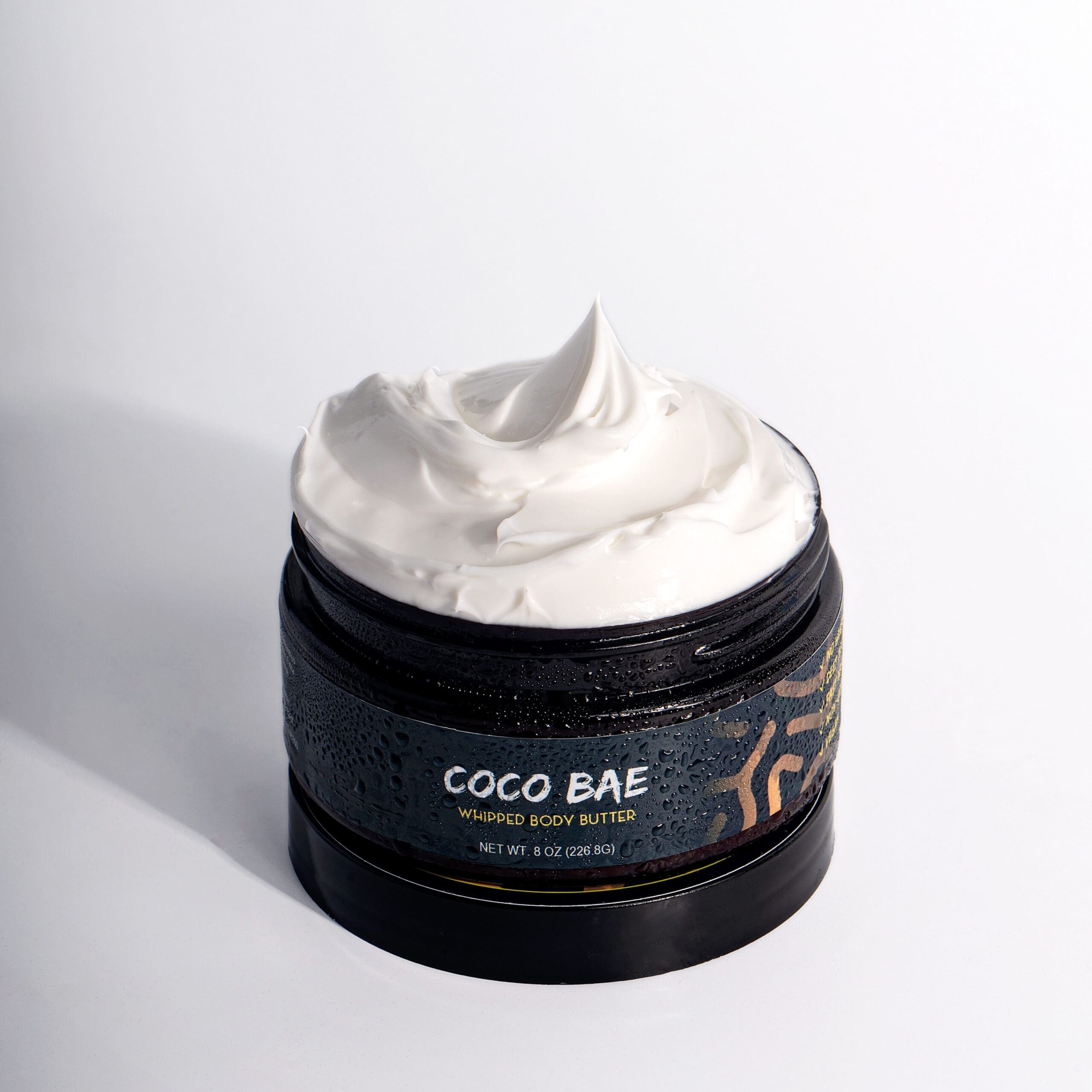 Coco Xo Bae Butter whipped body butter shown in an open jar, featuring a rich, creamy texture against a clean white background.