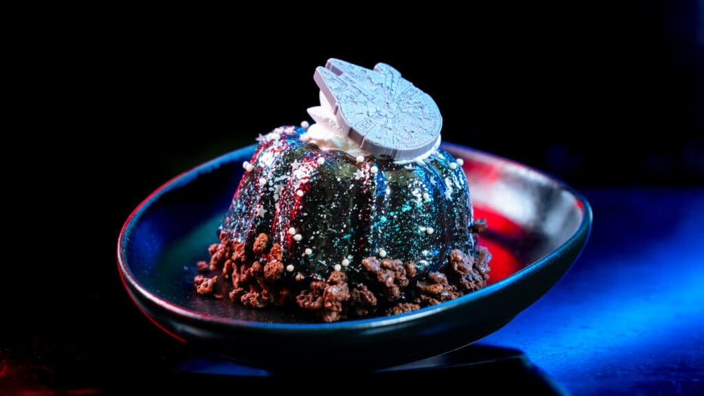 Galactic Bundt Cake served during Disneyland After Dark Star Wars Nite with Millennium Falcon decoration on top.