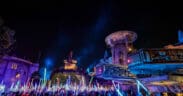 Disneyland After Dark Star Wars Nite with crowds waving illuminated lightsabers in Galaxy’s Edge after hours.