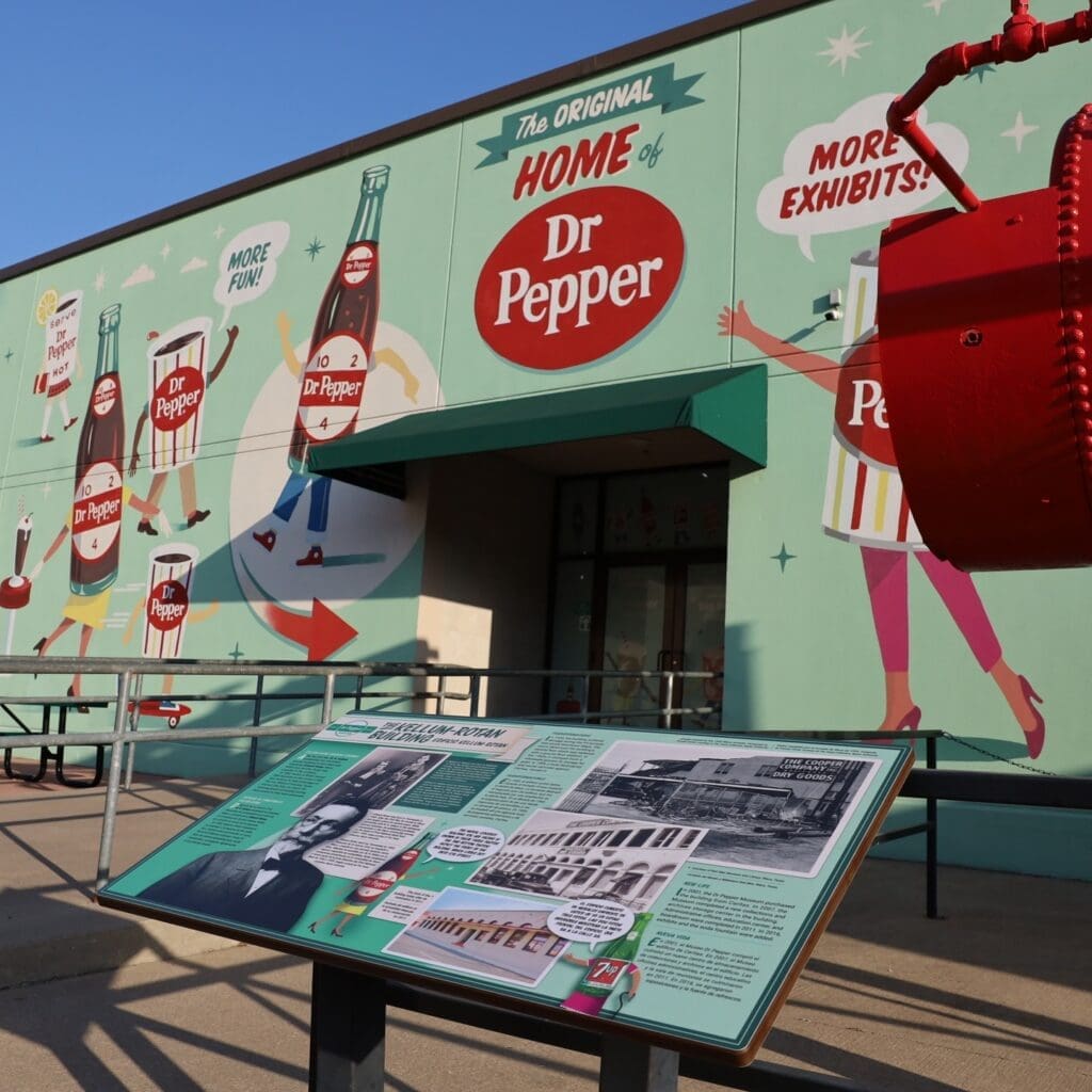 Colorful exterior mural at the Dr Pepper Museum in Waco, Texas featuring vintage Dr Pepper graphics.