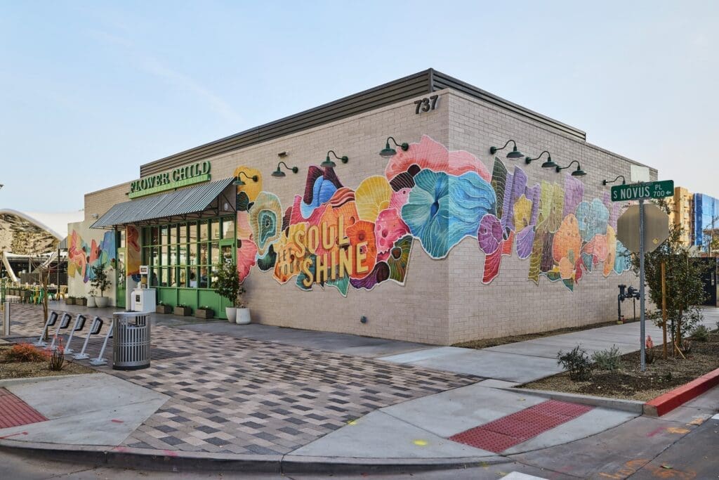 Exterior of Flower Child at Novus Place in Tempe featuring a bright floral mural that reads “Soul Shine.”