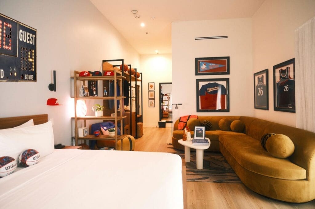 Poolside bar at The Anthem Hotel with woven pendant lights, bar seating and mounted televisions.