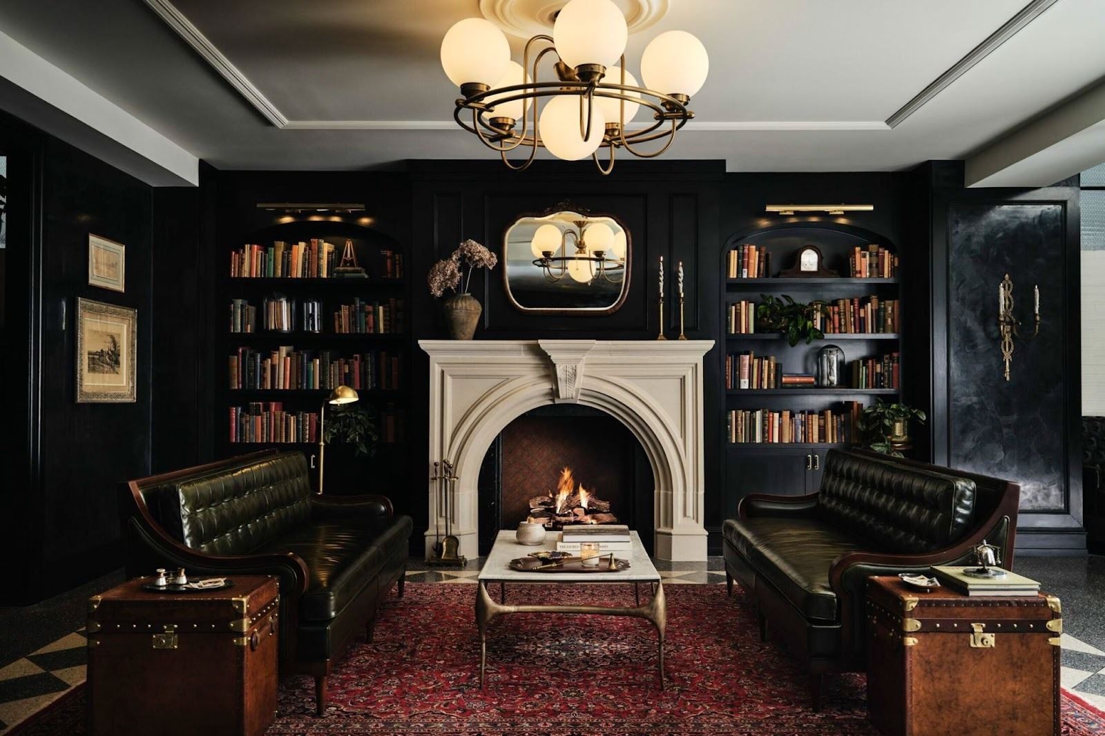 Elegant lounge inside Hotel 1928 in Waco, Texas with fireplace, leather sofas and bookshelves.