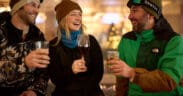Guests in ski gear enjoy après drinks together at Hotel Alpenrock in Breckenridge, celebrating winter dining and social moments indoors.