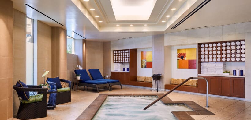 Indoor spa whirlpool at JW Marriott Desert Springs Resort & Spa with bubbling water, lounge chairs and warm neutral tile design in Palm Desert.